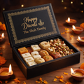 Black leatherette gift box engraved in gold with Happy Diwali and The Shah Family, filled with mithai and dry fruits