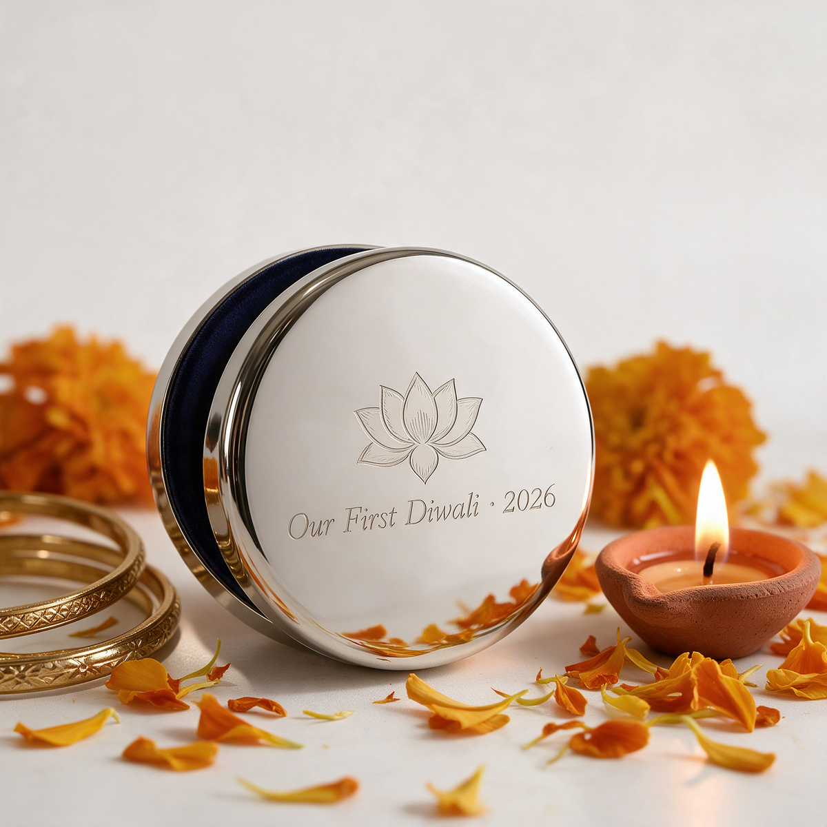 Round silver keepsake box engraved with a lotus and Our First Diwali 2026